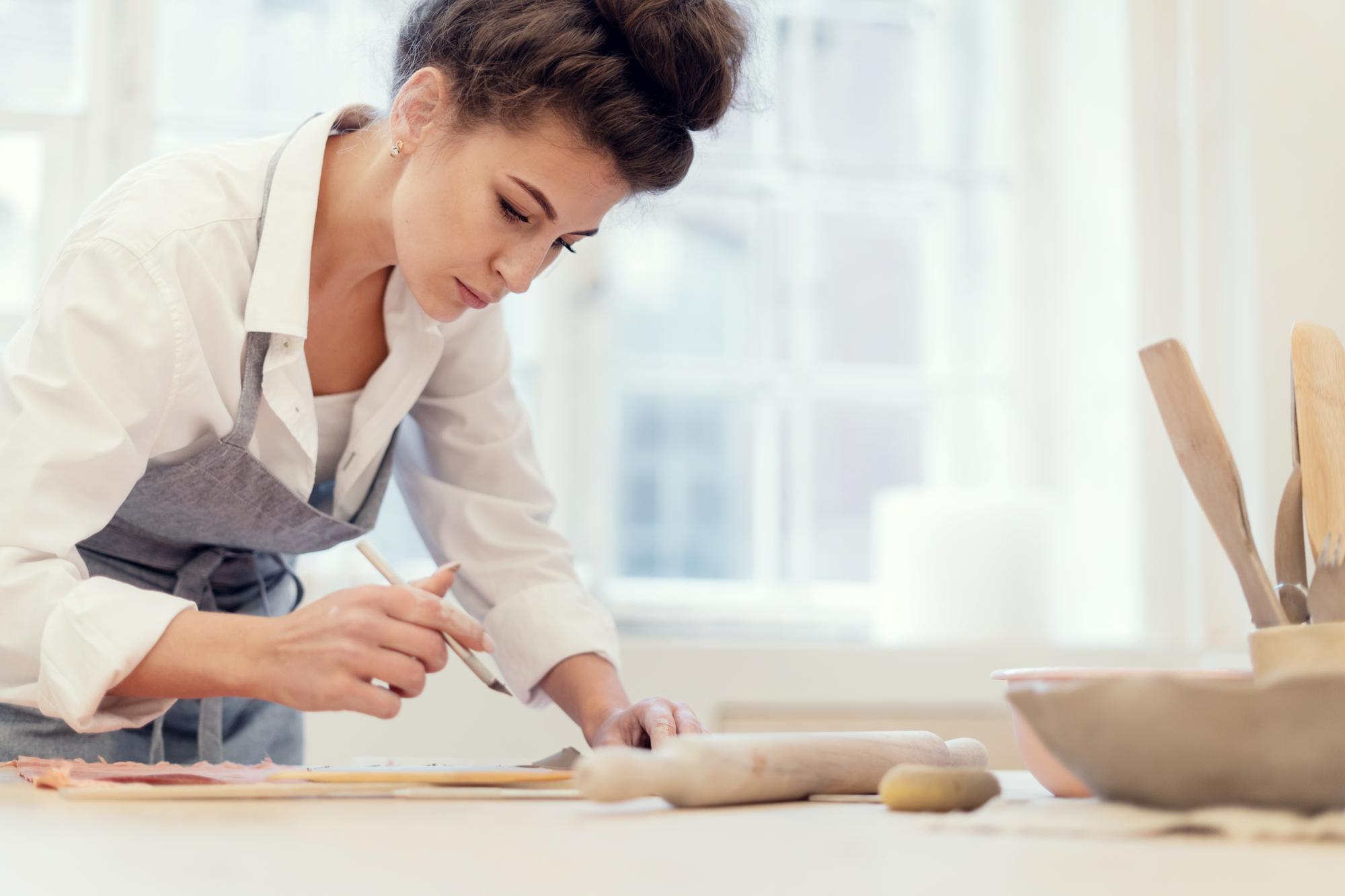 Student kneading dough in sunlight